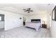 Spacious bedroom with a tray ceiling, ceiling fan, and en-suite bathroom access at 6199 N Caraway Dr, McCordsville, IN 46055