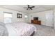 Bright bedroom featuring a tray ceiling, ceiling fan, and beautiful water views at 6199 N Caraway Dr, McCordsville, IN 46055