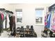 Walk-in closet featuring built-in shelving and natural light from two windows at 6199 N Caraway Dr, McCordsville, IN 46055