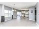 Open-concept dining area with views to kitchen, featuring large windows and modern lighting at 6199 N Caraway Dr, McCordsville, IN 46055