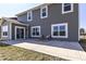 Exterior view of home featuring a patio area, well-maintained grass and yard, and large sliding glass doors at 6199 N Caraway Dr, McCordsville, IN 46055