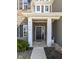 Close-up of the front door with address, decorative columns, and neat landscaping at 6199 N Caraway Dr, McCordsville, IN 46055