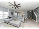 Spacious living room with a large gray sectional, modern fan, and open layout at 6199 N Caraway Dr, McCordsville, IN 46055