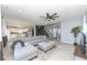 Bright living room featuring a gray sectional, open floor plan, and modern decor at 6199 N Caraway Dr, McCordsville, IN 46055