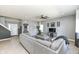 Comfortable living room with gray sectional, TV, and seamless flow to other rooms at 6199 N Caraway Dr, McCordsville, IN 46055