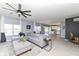 Open-concept living room with a gray sectional sofa and views into the kitchen at 6199 N Caraway Dr, McCordsville, IN 46055
