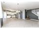 Spacious living room with open layout leading to kitchen, featuring tile floors and neutral paint scheme at 6199 N Caraway Dr, McCordsville, IN 46055