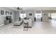 Spacious living room with tile flooring, a comfortable gray sectional, and windows offering great natural light at 6199 N Caraway Dr, McCordsville, IN 46055