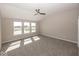 Bedroom with ceiling fan, carpeted floors, and natural light from the large windows at 6323 Willow Branch Way, Plainfield, IN 46168
