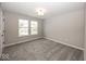 Well-lit carpeted bedroom with two windows at 6323 Willow Branch Way, Plainfield, IN 46168
