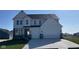 Charming two-story home boasts a three-car garage, stone accents, and a well-manicured lawn at 6323 Willow Branch Way, Plainfield, IN 46168