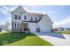 Charming two-story home with stone accents, three-car garage, and well-manicured lawn at 6323 Willow Branch Way, Plainfield, IN 46168