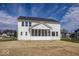 Exterior view of a white home with a screened-in porch and a spacious backyard under a blue sky at 6323 Willow Branch Way, Plainfield, IN 46168