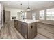 Modern kitchen with large island, stainless steel appliances, and hardwood flooring at 6323 Willow Branch Way, Plainfield, IN 46168