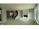 Open concept living room boasts a fireplace, staircase, and large windows providing natural light at 6323 Willow Branch Way, Plainfield, IN 46168