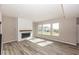 Spacious living room featuring modern fireplace and large windows at 6323 Willow Branch Way, Plainfield, IN 46168
