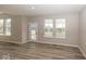 Bright living room with hardwood floors and large windows, great sunlight exposure at 6323 Willow Branch Way, Plainfield, IN 46168