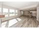 Open-concept living room flowing into the kitchen, with large windows overlooking the backyard at 6323 Willow Branch Way, Plainfield, IN 46168
