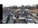 A high-angle aerial view of the home and surrounding neighborhood, showing the backyard and nearby homes at 644 S Cole St, Indianapolis, IN 46241