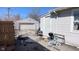 View of backyard showing garage and the side of the house, some outdoor chairs and a bicycle at 644 S Cole St, Indianapolis, IN 46241