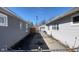 A wide driveway view showcases the space between two houses leading to a detached garage and backyard area at 644 S Cole St, Indianapolis, IN 46241