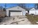 Backyard of the house showcasing a detached garage, driveway and an enclosed trailer at 644 S Cole St, Indianapolis, IN 46241