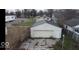 Aerial view of detached garage in backyard, surrounded by lush trees and neighboring houses at 644 S Cole St, Indianapolis, IN 46241