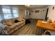 Sun-drenched living room featuring a comfortable sofa, wood table and hardwood flooring at 644 S Cole St, Indianapolis, IN 46241