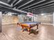 Finished basement with a pool table, exposed ceiling, and unique wood-paneled accent wall at 6620 Avalon Blvd, Avon, IN 46123