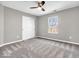 A cozy bedroom featuring neutral walls, carpet, a ceiling fan, and a window at 6620 Avalon Blvd, Avon, IN 46123