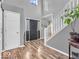 Bright entryway featuring hardwood floors, staircase, neutral paint and modern decor at 6620 Avalon Blvd, Avon, IN 46123