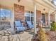 Relaxing front porch with comfortable seating, brick accents and a quaint garden at 6620 Avalon Blvd, Avon, IN 46123