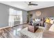 Bright living room featuring a ceiling fan, stylish decor, and updated vinyl plank flooring at 6620 Avalon Blvd, Avon, IN 46123
