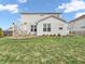 Relaxing backyard with a patio, fenced perimeter, and views of the home's stylish facade at 6915 Diamondleaf Way, Brownsburg, IN 46112