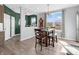 Beautiful dining room with seating and a view through the large window at 6915 Diamondleaf Way, Brownsburg, IN 46112