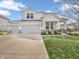 Two-story home with white siding, a well-manicured lawn, and a three car garage at 6915 Diamondleaf Way, Brownsburg, IN 46112