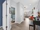 Open-concept foyer with hardwood floors, a nearby half-bath, and an entryway to the living room at 6915 Diamondleaf Way, Brownsburg, IN 46112
