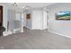 Upstairs hallway with neutral gray carpet, multiple doors and a wall mounted TV at 6915 Diamondleaf Way, Brownsburg, IN 46112