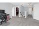 Hallway with access to laundry room, neutral gray carpet, and modern lighting at 6915 Diamondleaf Way, Brownsburg, IN 46112