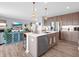 Modern kitchen with island seating and open view to the comfortable living room at 6915 Diamondleaf Way, Brownsburg, IN 46112