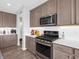Bright kitchen featuring a stainless steel oven, microwave, and ample counter space at 6915 Diamondleaf Way, Brownsburg, IN 46112