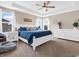 Spacious main bedroom with tray ceiling, ceiling fan, and natural light from large windows at 6915 Diamondleaf Way, Brownsburg, IN 46112