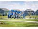 A sunny community playground area with blue play structures and green spaces at 6915 Diamondleaf Way, Brownsburg, IN 46112
