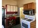 Kitchen featuring a gas range, microwave, and abundant cabinet space at 710 E 6Th St, Anderson, IN 46012