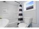 This bathroom features a shower with blue-striped curtain, and a toilet next to a window at 721 E Morris St, Indianapolis, IN 46203