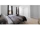 This bedroom features neutral walls, carpet, a black-out curtain, and a spacious closet with mirrored doors at 721 E Morris St, Indianapolis, IN 46203