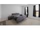 Bedroom with neutral carpet, modern furniture, and large windows for natural light at 721 E Morris St, Indianapolis, IN 46203