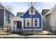 Charming two-story blue home with a well-manicured front yard and inviting curb appeal at 721 E Morris St, Indianapolis, IN 46203