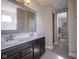 Double vanity bathroom with a large mirror and walk-in closet access, perfect for a Primary suite at 7228 Broadacre Ct, Carmel, IN 46033