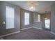 Carpeted bonus room featuring a decorative chandelier and multiple windows offering ample natural light at 7228 Broadacre Ct, Carmel, IN 46033